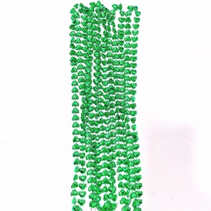 Close-up of shiny green clover-shaped bead necklaces for St. Patrick's Day party decor