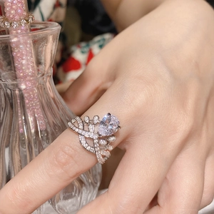 Victoria pear cut ruby ring in 18K gold plating worn by model with pearl decor