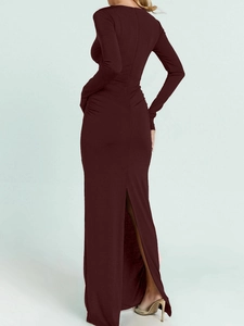 Detail of burgundy backless dress showing a sleek cutout design and elegant high slit