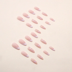 Matte almond press-on nails with French tips and pink heart designs for Valentines