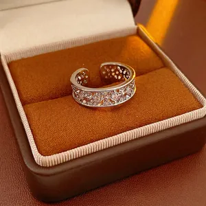 Exquisite adjustable silver ring with hollow flower design and sparkling zircon stones