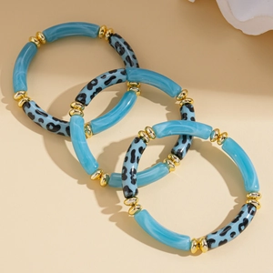 Detailed view of three-piece blue acrylic marble and leopard print stretch bracelets