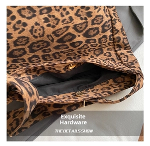Detail of golden magnetic snap closure and leopard print fabric on tote bag