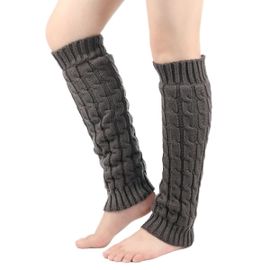 Detailed macro view of dark grey cable knit leg warmers with ribbed cuff texture