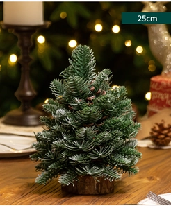 Detailed view of a 25cm mini Nordic Christmas tree with a natural wooden base on a table