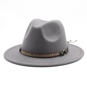 Detail view of grey wool fedora hat with ethnic patterned band and metallic buckle