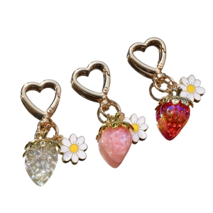 Cute strawberry keychain with daisy charms and heart-shaped metal clasps in three colors