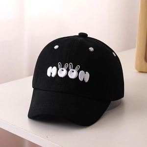 Close-up of white 3D embroidery with HOON letters and bunny ears on black cotton cap