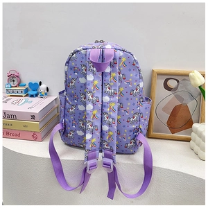 Detail of purple toddler backpack with unicorn prints, padded straps and side pockets
