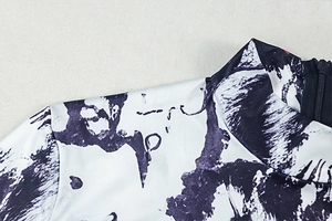 Detail of high neck stand collar and back invisible zipper on printed skinny jumpsuit