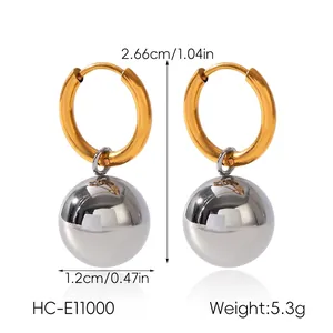 Detailed view of spherical drop earrings with dimensions of 2.66cm height and 1.2cm width