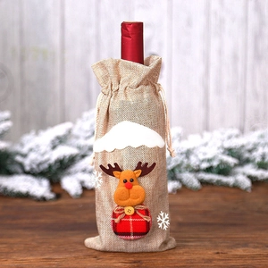 Detail of burlap Christmas wine bottle bag featuring a cute reindeer and plaid pattern