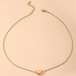 Detail of golden stainless steel bean pendant necklace with adjustable chain and lobster clasp