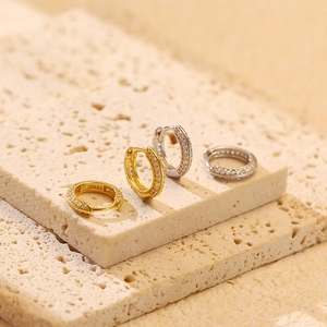 Macro detail of S925 sterling silver hoop earrings with pavé set zircon stones