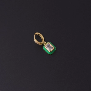 Close-up of gold huggie hoop earring with green enamel and emerald-cut zircon stone