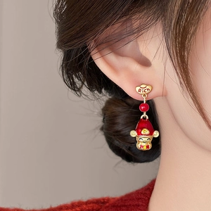 Detailed view of God of Wealth earring with red beads and golden heart stud for New Year