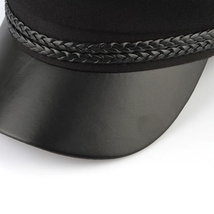 Detail of black navy cap featuring a PU leather brim and braided decorative rope band