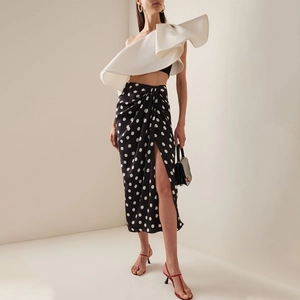 Chic two-piece swimwear featuring a white ruffled one-shoulder top and polka dot slit skirt