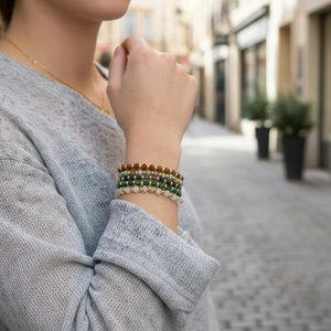 Close-up of stacked 4mm Amazonite facet beaded bracelets with gold plated metal spacers