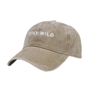 Washed khaki baseball cap with white STAY WILD embroidery and curved brim in 45-degree view