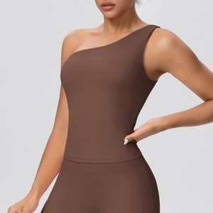 Detailed close-up of brown one-shoulder sports bra with seamless matte finish fabric
