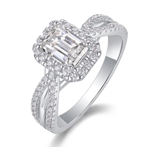 Close-up of emerald cut moissanite ring with halo setting and twisted pave band
