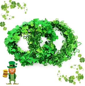 Detail of green St. Patrick's Day tinsel garland with shiny shamrock clover leaves
