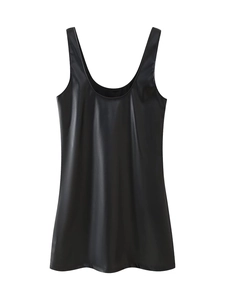 Detail of black faux leather strap dress showing smooth texture and glossy finish