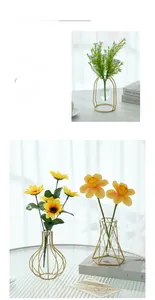 Detail of Nordic gold geometric metal frame vase with clear glass tube insert