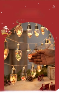 Detail of LED Christmas globe light with Santa Claus figurine and warm festive lighting