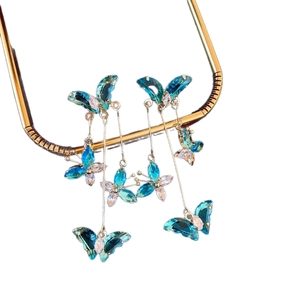 Elegant long fringe earrings with blue-green crystal butterflies and golden chains