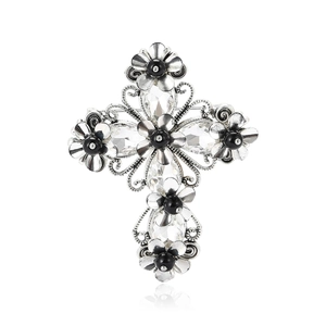 Vintage silver cross brooch with clear crystals and black beads on white background