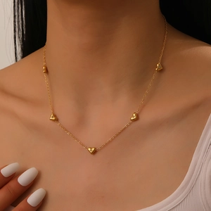 Elegant gold heart necklace for women featuring multiple diamond-set heart pendants