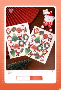 Detailed view of two Christmas cartoon sticker sheets with Santa and tree motifs