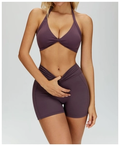 Detail of cross halter yoga bra with knot detail and V-shaped high waist fitness shorts