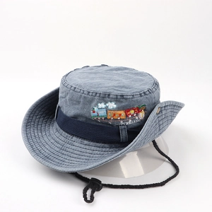 Detail of blue denim sun hat featuring colorful train embroidery and adjustable wind rope