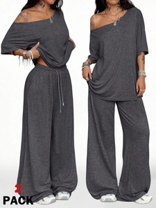 Detail of dark grey two-piece set featuring off-shoulder top and drawstring wide leg pants