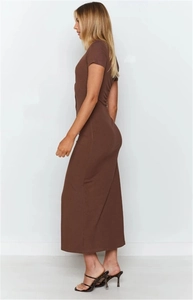 Side view of a slim fit brown maxi dress with V-neck and short sleeves on model