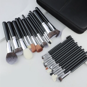 32-piece professional makeup brush set with silver ferrules and a black leather travel pouch