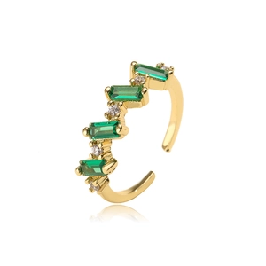 Detail of 18K gold-plated ring featuring green emerald-cut zircon and white crystals