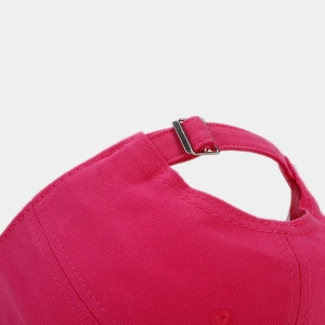 Macro detail of pink cotton baseball cap featuring adjustable silver metal buckle and stitching