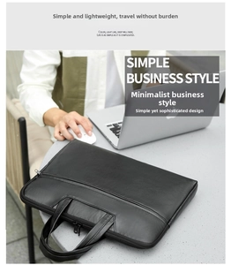Business style black leather laptop bag on desk showing textured surface and handles