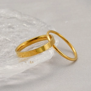 Golden double-layered stainless steel ring set on ice-cracked glass texture