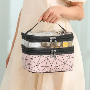 Pink quilted double-layer makeup bag with clear top compartment and heart-shaped zippers