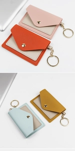 Detail of multi-color PU leather card holder with gold keychain and button closure