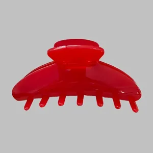 Close-up of a glossy red large acetate hair claw clip with strong spring and sturdy teeth