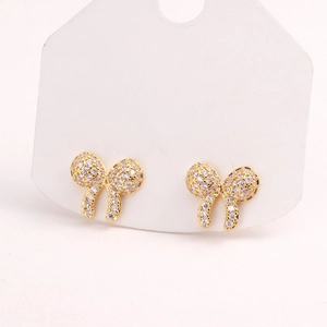 Close-up of sparkling pink bow earrings with zircons on a white display card