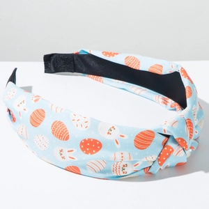 Close-up of Easter headband with bunny egg patterns and a stylish top knot detail