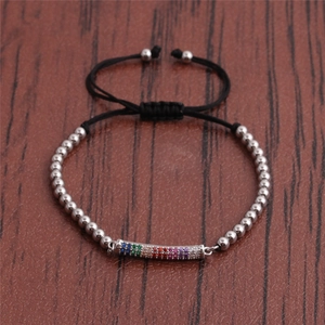 Adjustable rainbow zircon woven bracelet with silver beads on a wooden background