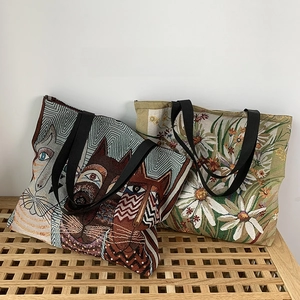 Macro view of woven floral and cat jacquard patterns on durable canvas tote bags